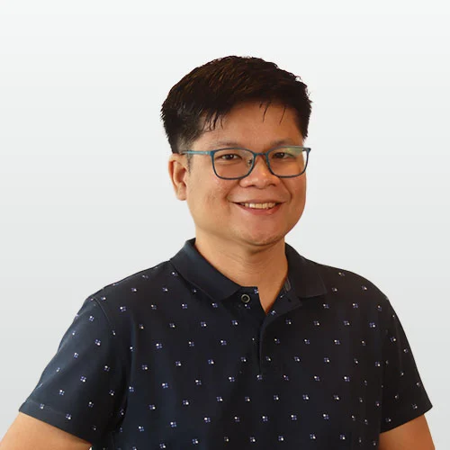 Professional headshot of JP Bantigue on plain background